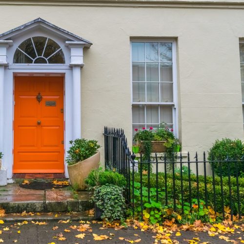 House,Facade,With,Orange,Front,Door,And,Front,Garden Composite Doors